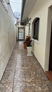 an empty hallway of a building with plants on it at Pousada e Hostel Rodo in São Carlos