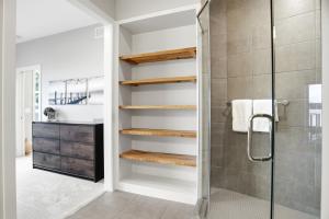 a bathroom with a walk in shower next to a glass door at Lakefront Luxury in Mound +92 photos