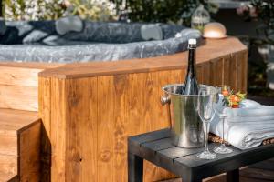 a bottle of wine in a bucket on a table at Casa Le Camelie idromassaggio e relax Lucca in Capannori