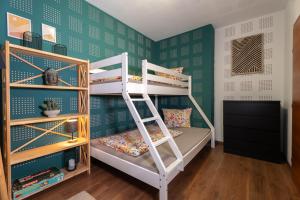 a bunk bed in a room with green walls at Alpenloft Bregenz in Bregenz