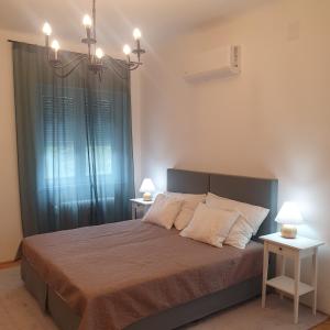 a bedroom with a large bed with two night stands at Bzs5 in Pécs