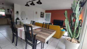 a dining room with a table and a cactus at L'écrin d'Ar Prajou in Plouénan