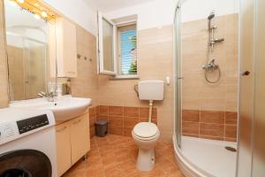 a bathroom with a toilet and a sink and a shower at Casa delle Rondini in Belej +23 photos