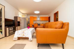a living room with a couch and a table at Casa delle Rondini in Belej
