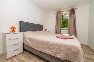 a bedroom with a bed and a dresser and a window at Casa delle Rondini in Belej