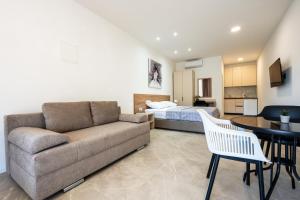 a living room with a couch and a bed at Apartments Obradović in Neum