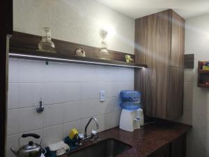 a kitchen with a sink and a counter top at Cabaña Lodge Araucaria ll in Eduardo Castex +3 photos