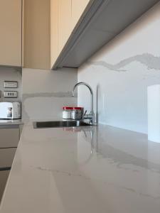a kitchen with a sink and a counter top at New CP Victory suites studio sleeps 4 with pool and gym in Gibraltar
