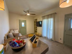 a living room with a couch and a table at Mikres Cyclades - Koufonisia House in Koufonisia