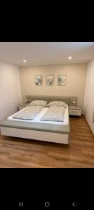 a bedroom with a large bed with two pillows at Haus Haslauer in Strobl