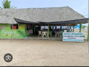 a store on the beach with tables and chairs at punta bolivar in San Antero +2 photos