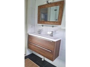 a bathroom with a sink and a mirror at Bungalow in Breskens near Beach & Lighthouse in Breskens +11 photos