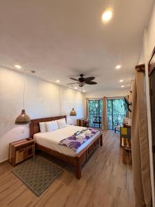 a bedroom with a bed and a ceiling fan at Falling Leaves Lodge in San Ignacio +67 photos