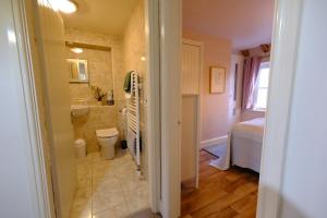 a bathroom with a sink and a toilet and a tub at Rose Cottage in Buxton +26 photos