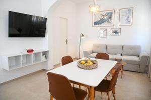 a living room with a table and a couch at Mandrakia Living House in Mandrakia