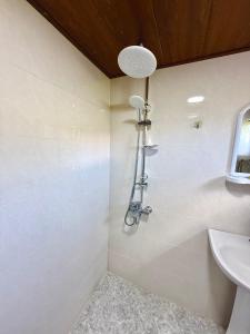 a bathroom with a shower and a sink at Guesthouse Roza in Tsvirmi