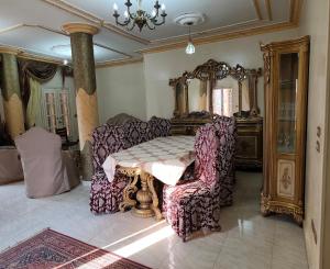 a room with a table and two chairs and a mirror at Sunset Mirage House in Giza