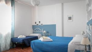 a blue and white bedroom with two beds at Villa al Mare - Cala Gonone in Dorgali
