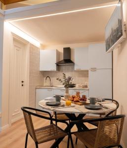 a kitchen with a table and chairs in a room at Tiny Park House in Sabaudia