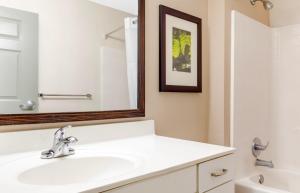 a white bathroom with a sink and a mirror at Extended Stay America Suites - Fort Worth - Fossil Creek in Fort Worth +57 photos