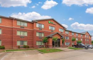 a red brick building with a sign on it at Extended Stay America Suites - Fort Worth - Fossil Creek in Fort Worth