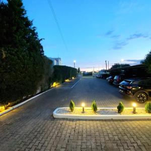 a street with a parking lot with cars and lights at Manta Guest - Bed & Breakfast in Manta Rota