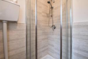 a shower with a glass door in a bathroom at Al Agave sotto in Toscolano Maderno +16 photos