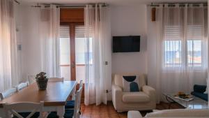 a living room with a dining room table and chairs at Villa al Mare - Cala Gonone in Dorgali