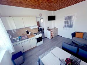 a kitchen and living room with a couch and a table at Peđa in Ogulin