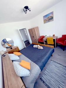 a bedroom with a bed and a table and chairs at Peđa in Ogulin