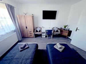 a living room with a couch and a table and a television at Peđa in Ogulin