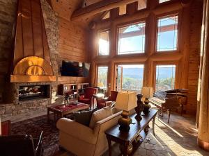 a living room with a couch and a fireplace at Hamatreya- Panoramic Shenandoah Views in Rileyville +65 photos