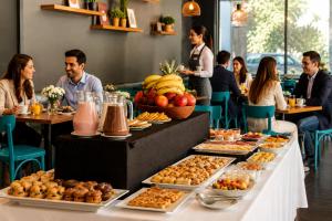a buffet of food on a table in a restaurant at Novapark in Santiago