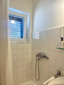 a bathroom with a shower and a window at Falcon in Mali Lošinj +17 photos