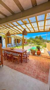 a patio with a table and chairs on a brick patio at Casa Mangaba da Praia in Prado