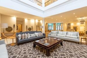 a living room with two couches and a coffee table at Burapha hotel in Ban Ta Sang
