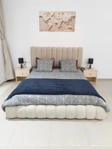 a bedroom with a large bed and two night stands at Villa Inaya in Tasdert +90 photos