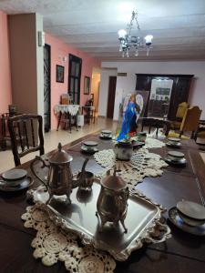 a dining room table with pots and pans on it at Hotel America in Victoria