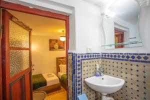 a bathroom with a sink and a mirror at Dar Iline - RoofTop in Fez