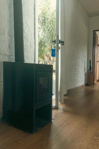 a television sitting in a living room next to a door at Skyblue Park in Piriápolis +93 photos