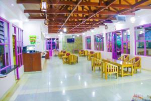 a restaurant with tables and chairs in a room at Destination Resort Centre in Gikuu