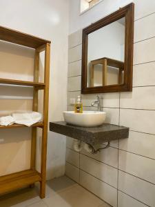 a bathroom with a sink and a mirror at Hotel Restaurante Los Cocos in Santa Cruz +90 photos