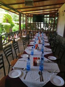 a long table with plates and water bottles on it at Destination Resort Centre in Gikuu