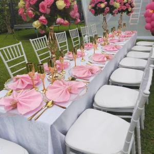 a long table with pink napkins and champagne glasses at Destination Resort Centre in Gikuu