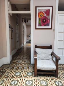a hallway with a chair and a picture on the wall at Santa Beatriz in Lima