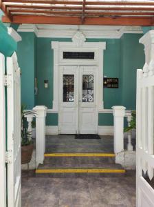 a white door in a blue room with stairs at Santa Beatriz in Lima