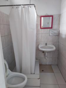 a bathroom with a toilet and a sink at Santa Beatriz in Lima +3 photos
