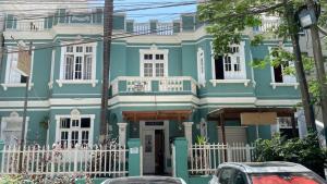 a blue house with a white fence in front of it at Santa Beatriz in Lima