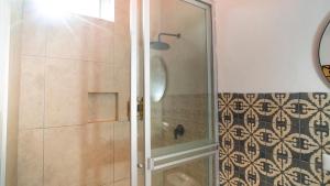 a shower with a glass door in a bathroom at qema Mancora in Máncora