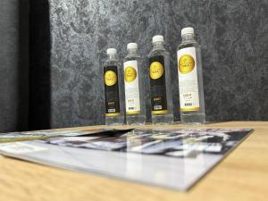 a group of five bottles sitting on top of a table at Apartmani Benjamin in Tuzla